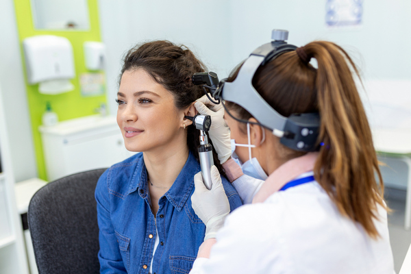 Doctor checking patients ears